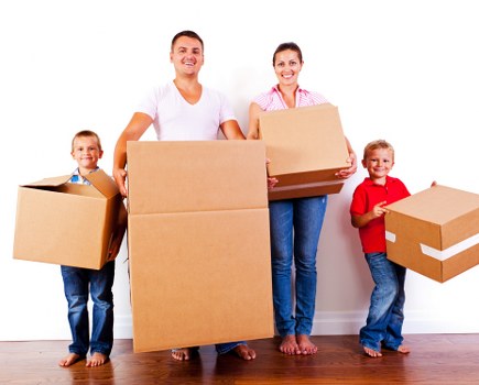 Moving boxes and office furniture staged for delivery to a new workspace