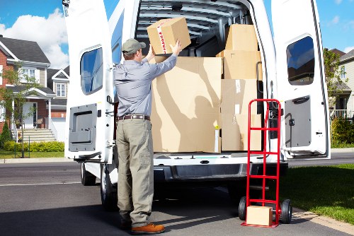 Worker using proper manual handling practices with a trolley