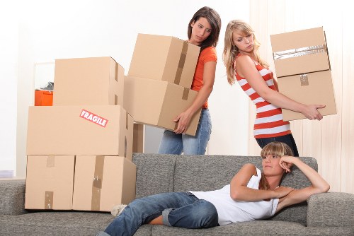 Movers handling furniture carefully during a Hampstead flat relocation